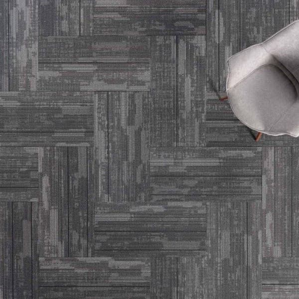 J&J Flooring Fast Track Carpet Plank, Breakout pattern — gray and charcoal textured carpet tiles in a parquet layout with