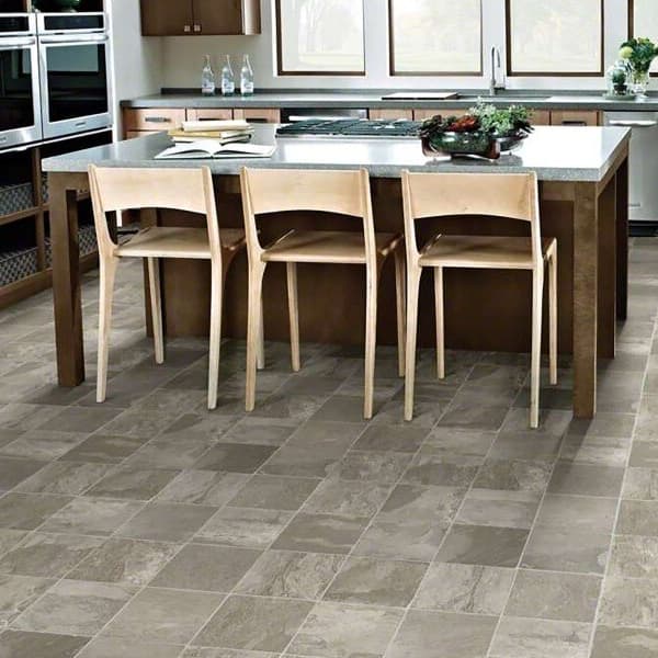 Shaw Great Basin 12' wide vinyl sheet flooring in Keystone pattern — kitchen with gray stone-look tiles under island and