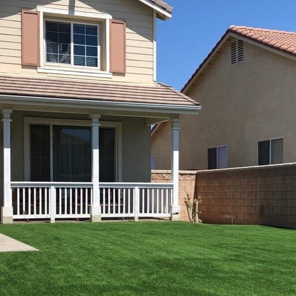 Eco Choice Turf Rolls, Summer/Emerald Green — artificial grass installed in front yard of suburban home with porch and brick