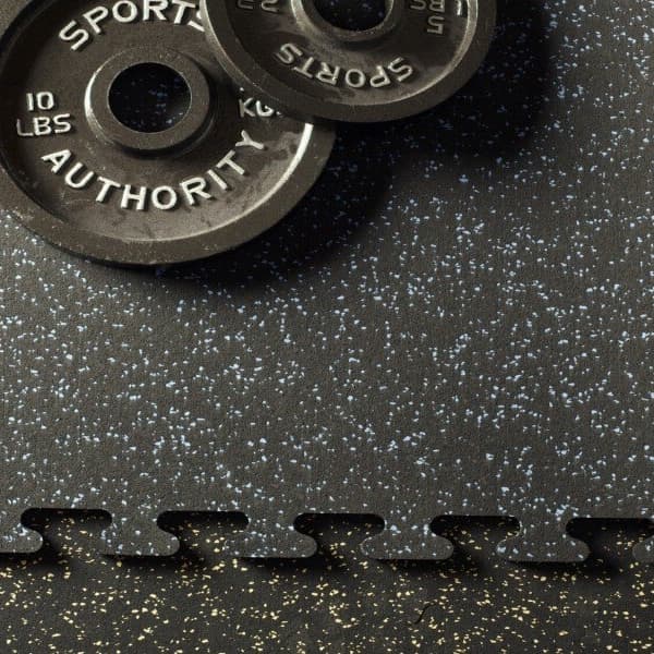 Black 10lb weights sitting on black interlocking rubber tiles.