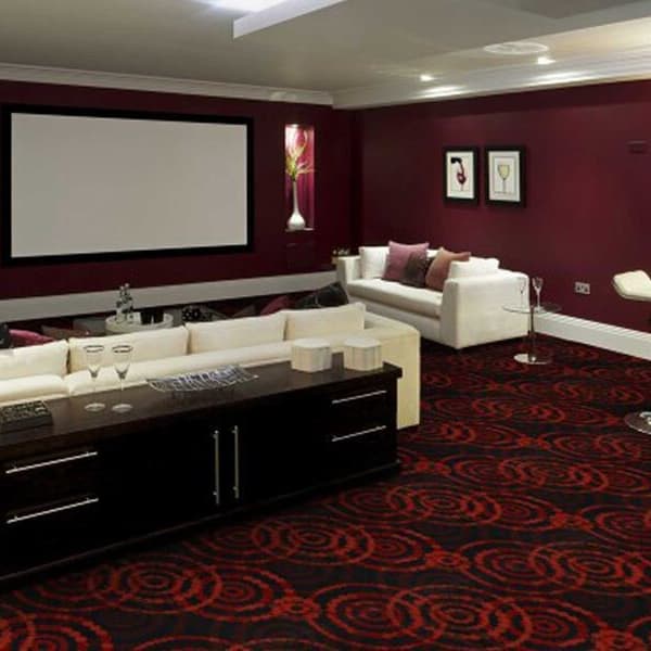 Joy Carpets Dottie Carpet, Ruby — home theater with red and black circular pattern carpet