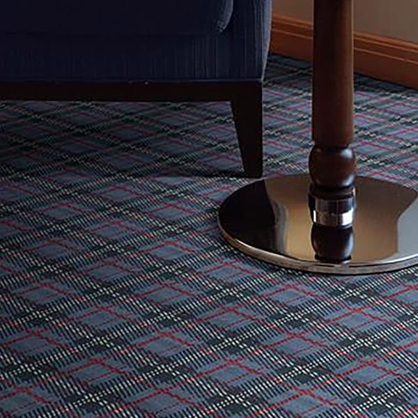 Shaw Scottish Plaid Carpet, Highlands — living room floor with blue and red plaid pattern under a chair and table base