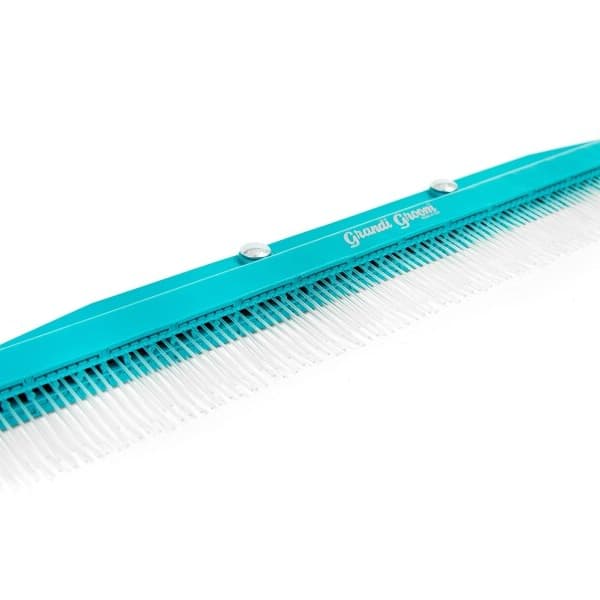 Artificial turf rake on white background.