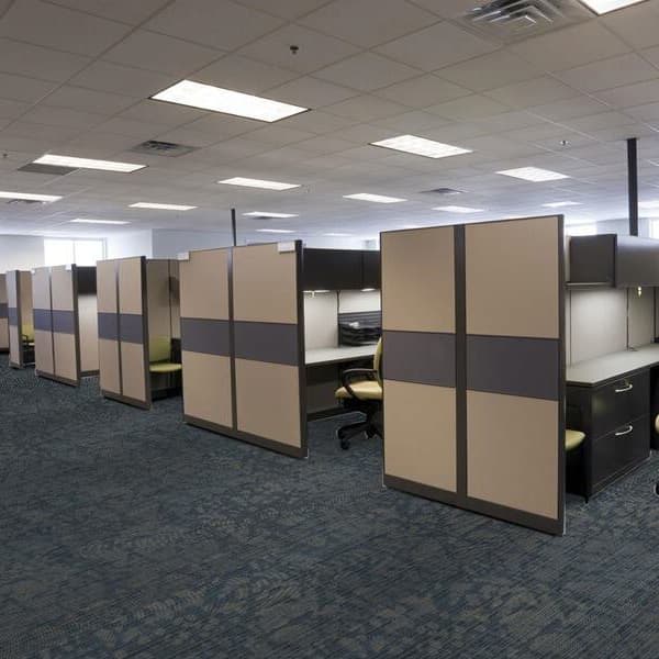 Office with blue and gray abstract pattern carpet tile under cubicle workstations