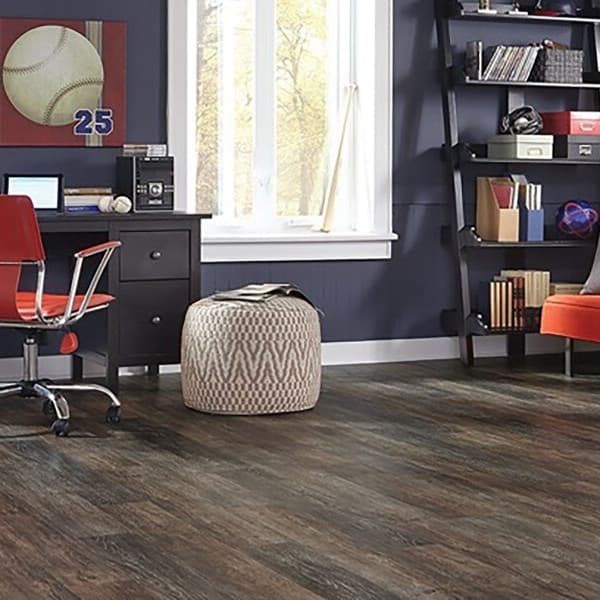 Adura Flex 6" vinyl plank flooring in Dockside Driftwood — room with desk, chair, ottoman, and sofa