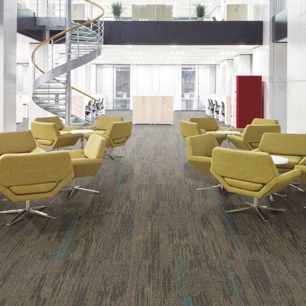 Mannington Span Carpet Tiles, Metro pattern — modern office lounge with gray and teal textured carpet tiles under yellow