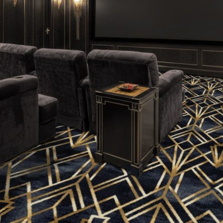 Joy Carpets Midnight Gild Carpet in Sapphire — home theater with dark blue and gold geometric pattern carpet under plush