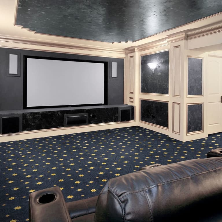 Home theater with dark blue carpet featuring a gold star pattern