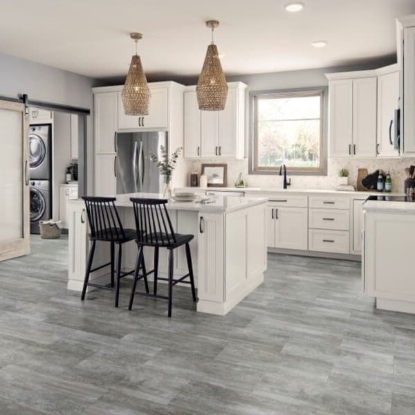 Kitchen with Mannington Realta 12" rigid core vinyl planks in Patina Ash, light gray wood grain flooring under white