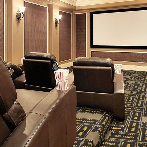 Home theater with Joy Carpets Admit One Carpet in black and gold ticket pattern, under leather recliners