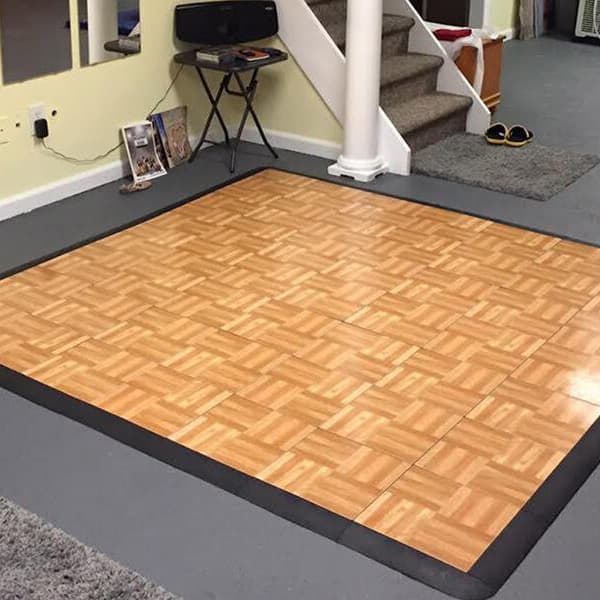Modular dance floor kit in Oak pattern, parquet design, installed in a home studio space