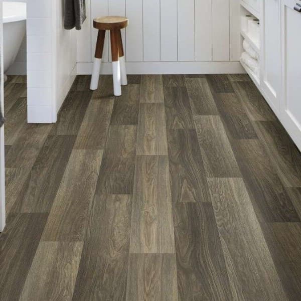 Shaw Great Basin II 12' Wide Vinyl Sheet in Legacy — bathroom with dark gray wood grain vinyl flooring, white cabinetry and
