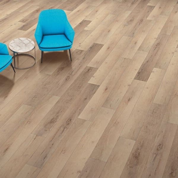 Rigid core vinyl plank flooring with two bright blue modern accent chairs and round marble-top side table.