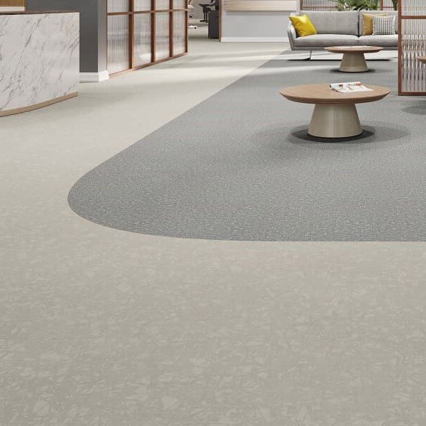 Mannington Meander 6' Vinyl Sheet in Shade — modern office lounge with curved light gray and beige speckled vinyl flooring