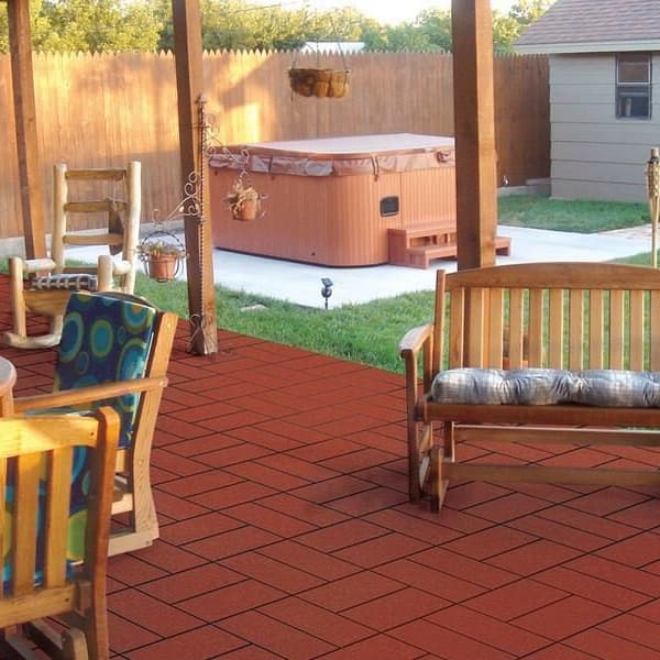 West Coast paver tiles in red — outdoor patio with wooden furniture and hot tub, flooring laid in herringbone pattern