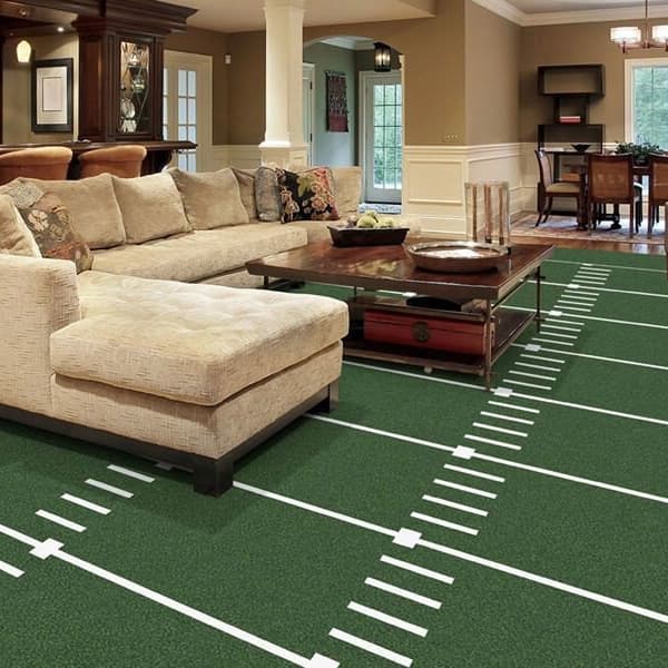 Joy Carpets Gridiron Carpet, Grass — green football field pattern carpet in a basement bar and living area