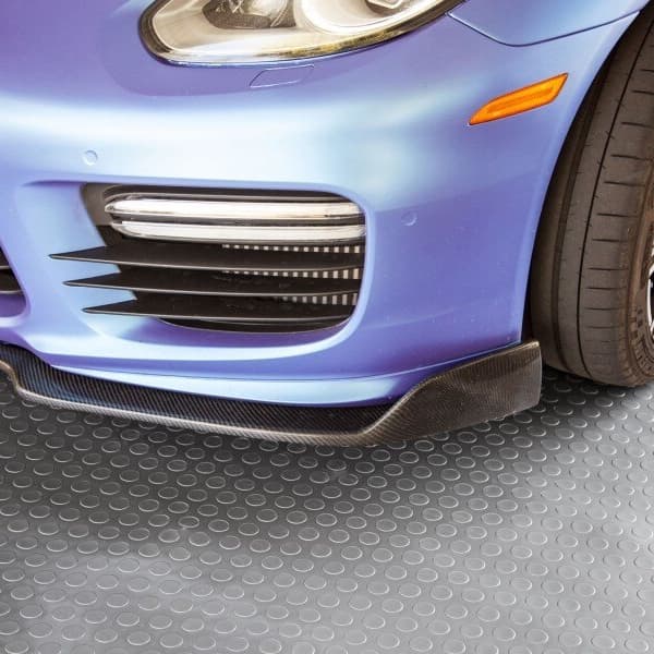 Car tire and body over Stainless Steel coin-pattern vinyl garage flooring.