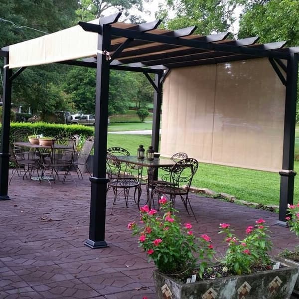 Flagstone Rubber Pavers in brown — outdoor patio with pergola, dining set, and flower planters
