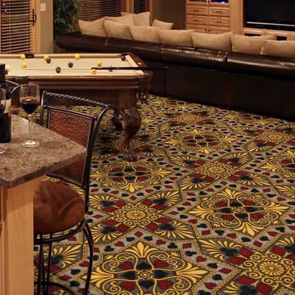 Joy Carpets Jackpot Carpet, red and gold pattern, in a game room with pool table and sectional sofa