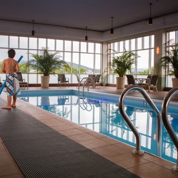 Indoor pool area with black Plastex Heronrib drainage mat along the edge