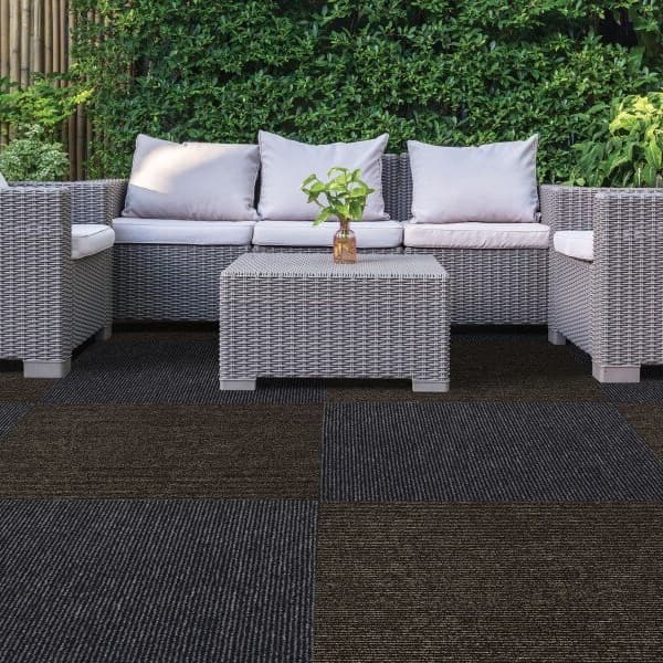 Picket Antimicrobial Carpet Tile in Granite and Taupe — patio scene with wicker furniture on patterned carpet tiles
