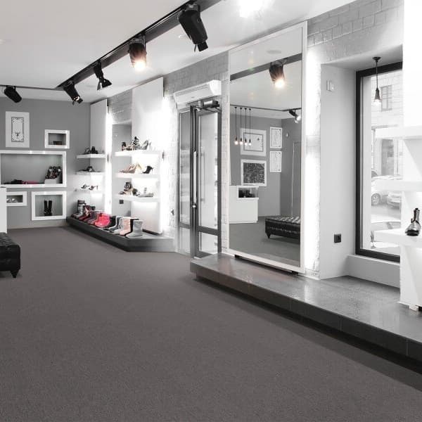 Pentz Colorpoint Carpet Tiles in Charcoal, covering the floor of a retail store
