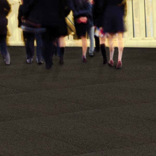 EF Contract Access Walk Off Carpet Tile, Channel — dark gray carpet tile in a busy pedestrian area