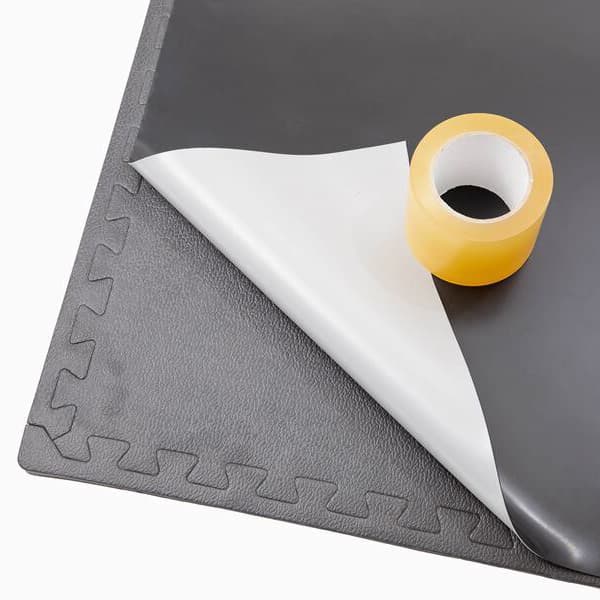 ProStep Dance Floor Package with Subfloor — gray EVA foam tile with interlocking edges, vinyl sheet backing peeled back, roll