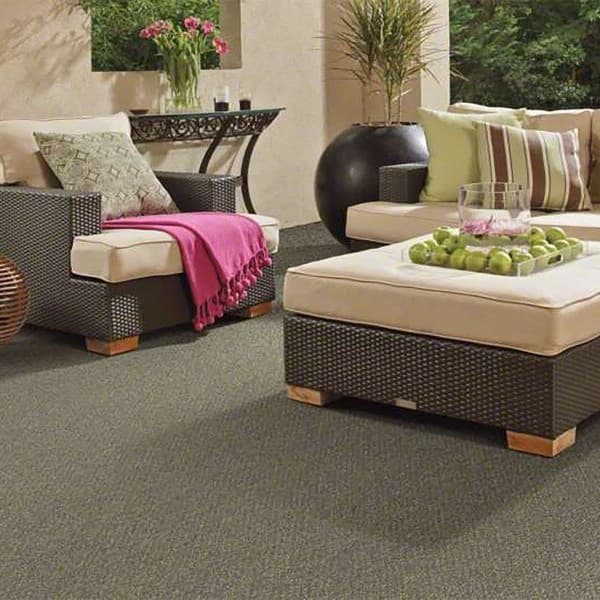 Shaw Natural Path Outdoor Carpet in Mineralite — patio with wicker furniture and beige cushions on gray textured carpet
