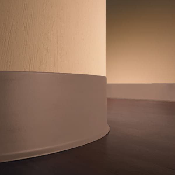 Eco Vinyl Wall Base — almond thermoplastic vinyl baseboard installed at wall-floor junction