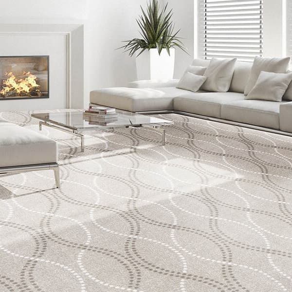 Joy Carpets Seventh Heaven Carpet, Ivory — living room with light beige carpet featuring a subtle wave pattern