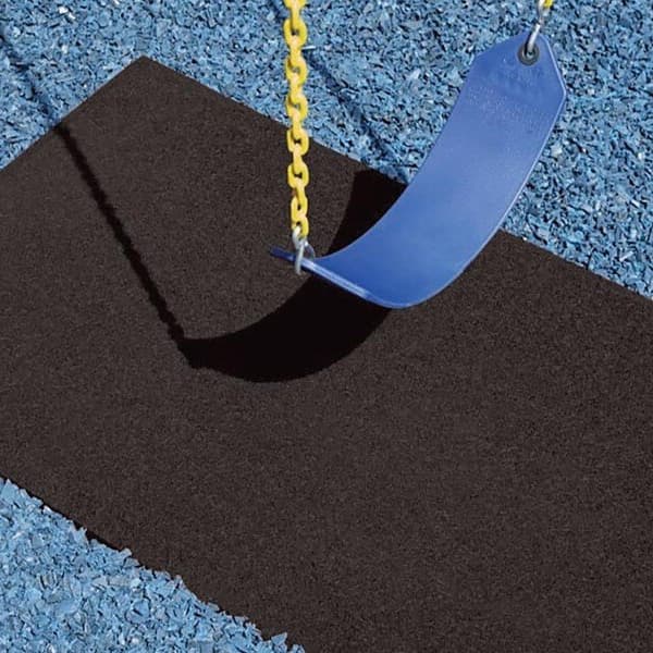 Playground swing mat, black — rectangular safety mat under a blue plastic swing seat with yellow chains, on blue rubber mulch