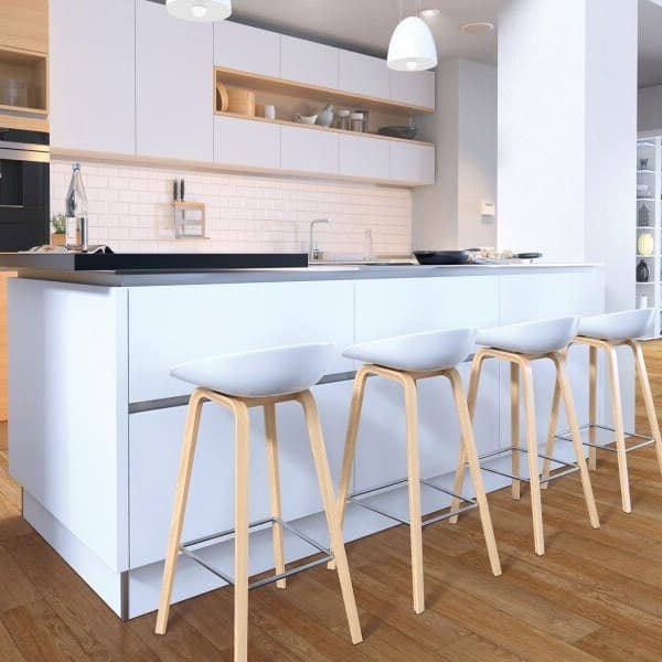 Waterproof vinyl planks in modern kitchen, white island with black countertop and white bar stools.
