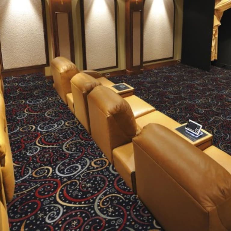Home theater with Joy Carpets Splendido Carpet in Cosmos pattern, dark blue base with red, white, and gold swirls