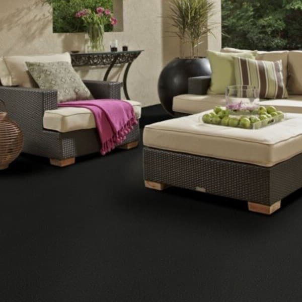 Shaw Softscape I Outdoor Carpet in Night Time — dark charcoal outdoor carpet under patio furniture with beige cushions and