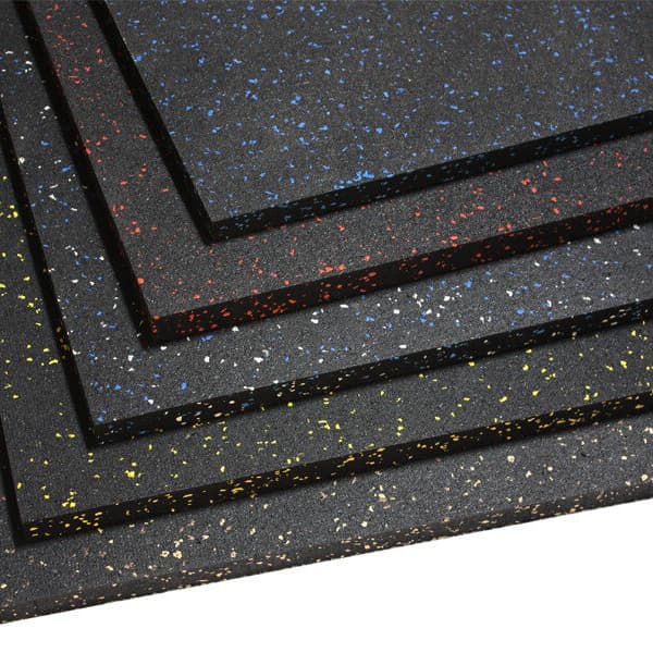 Rubber gym mats in a stack of five with colored speckled flecks in yellow, blue, red, and white.