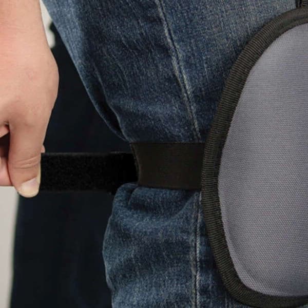 Washable Comfort Knee Pads, gray with black trim — close-up of pad worn on knee over jeans, showing adjustable strap and