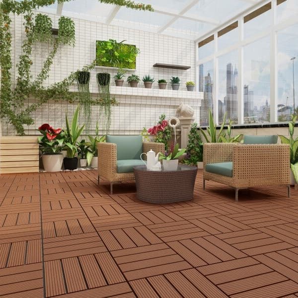 Terrace (4 Slat) composite deck tiles in Mocha — outdoor patio with wicker furniture and plants, city view through glass