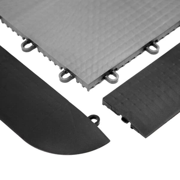 Sport Male Edges, Midnight Black — interlocking court flooring edge trim and grey tile surface close-up