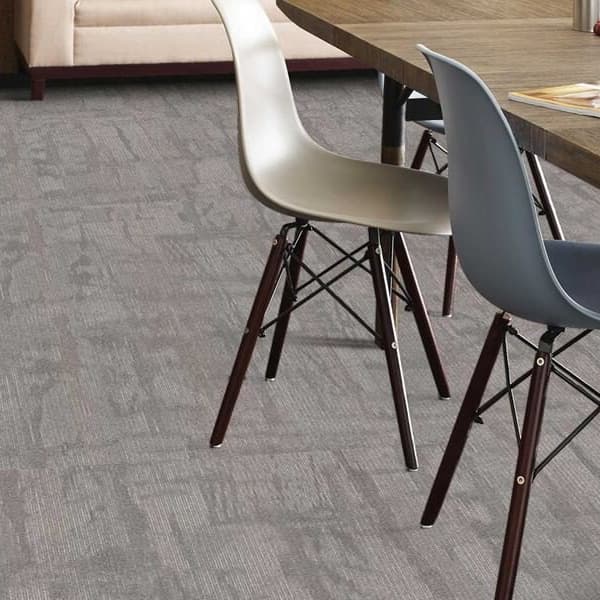Shaw Chiseled Carpet Tiles, Compose — gray textured carpet tile flooring in a dining area