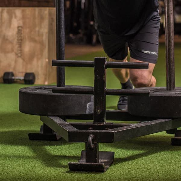 Green Shock Turf artificial grass in gym with weight rack and punching bag