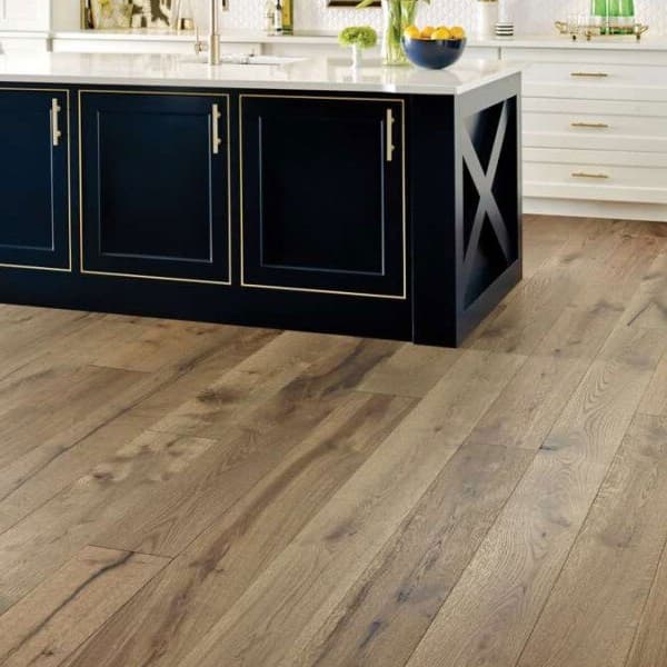 Shaw Reflections White Oak Engineered Wood, Terrain — kitchen with dark blue island and white cabinetry, wood flooring