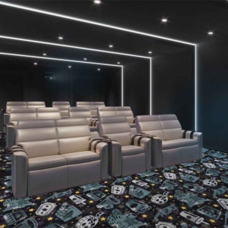Home theater with Joy Carpets Motion Picture Carpet in Navy — patterned carpet featuring film reels, cameras, and stars