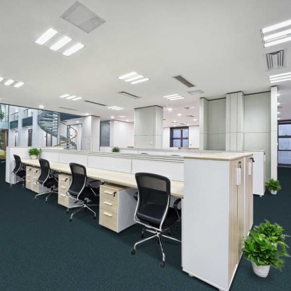 Office space with Pentz Uplink Carpet Tiles in 3122 Denim, covering the floor under desks and chairs
