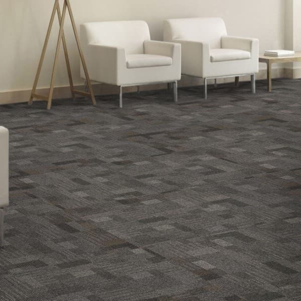 Mohawk Cityscope Carpet Tile, Town Square — office lounge with gray geometric pattern carpet tiles under white armchairs