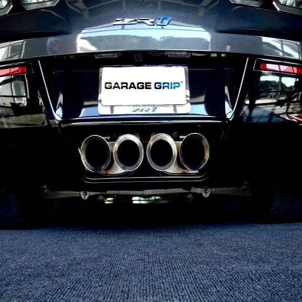 Garage Grip floor mat, charcoal, textured surface under car exhaust