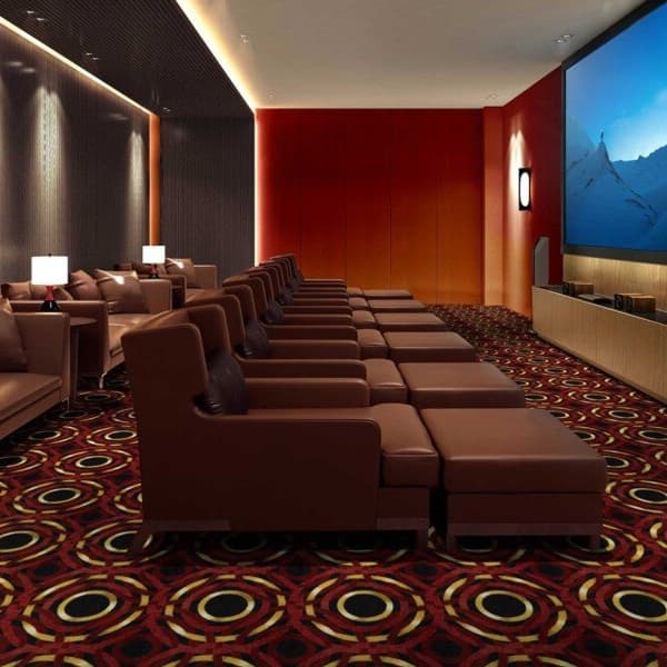 Joy Carpets Mayfair Carpet, Ruby — home theater with patterned carpet under rows of leather recliners and a large screen