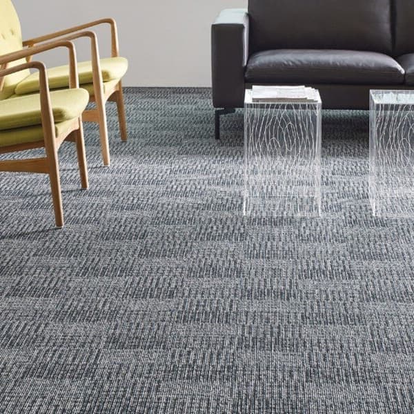 Shaw Fact Carpet, Conservative — gray textured carpet in a waiting area with yellow chairs and a black sofa
