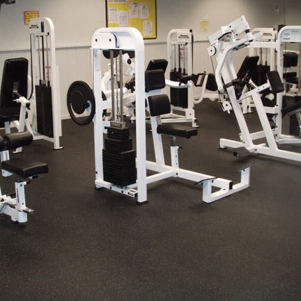 1/2" Pre-Cut Mega Rubber Gym Rolls used in a commercial gym with different workout machines.