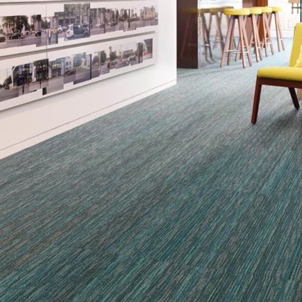 Shaw Stellar Carpet Planks, Abstract pattern — teal and gray textured carpet tile flooring in a modern office lounge